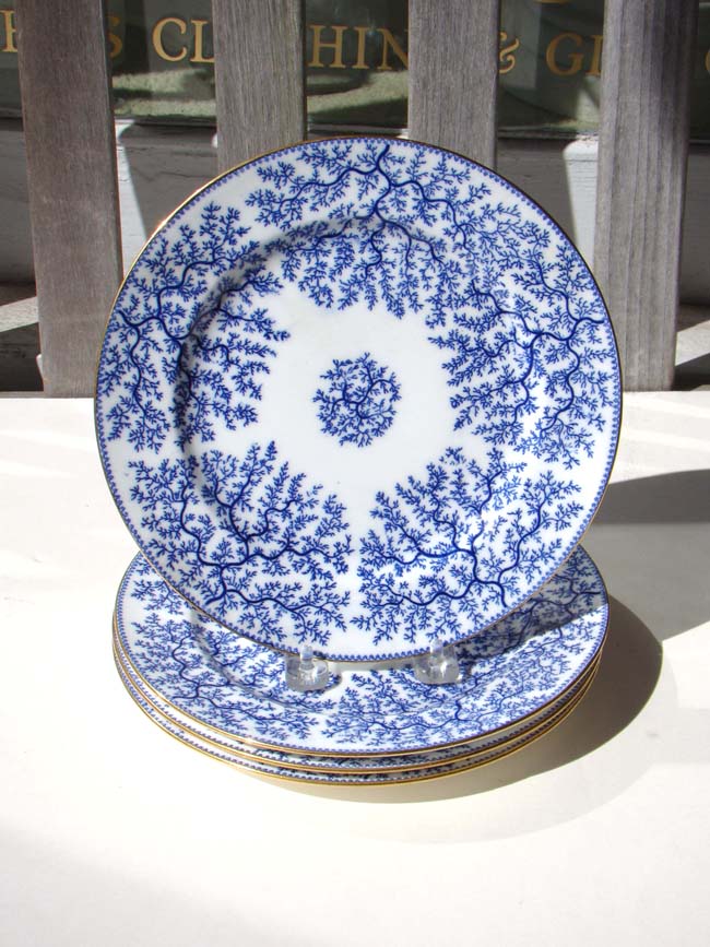 A set of four late 19th century Minton 9" plates with gold rims
